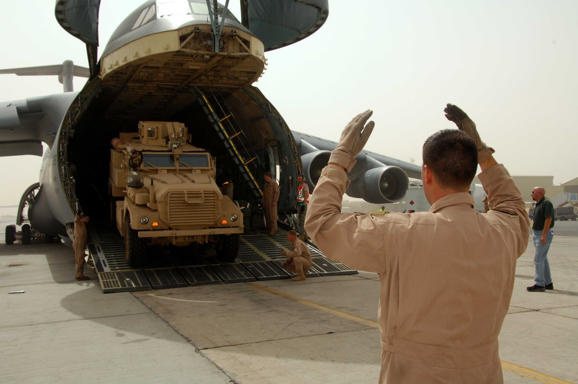 Team Travis members unload the 10,000th mine-resistant, ambush-protected vehicle in Southwest Asia recently. (U.S. Air Force photo)