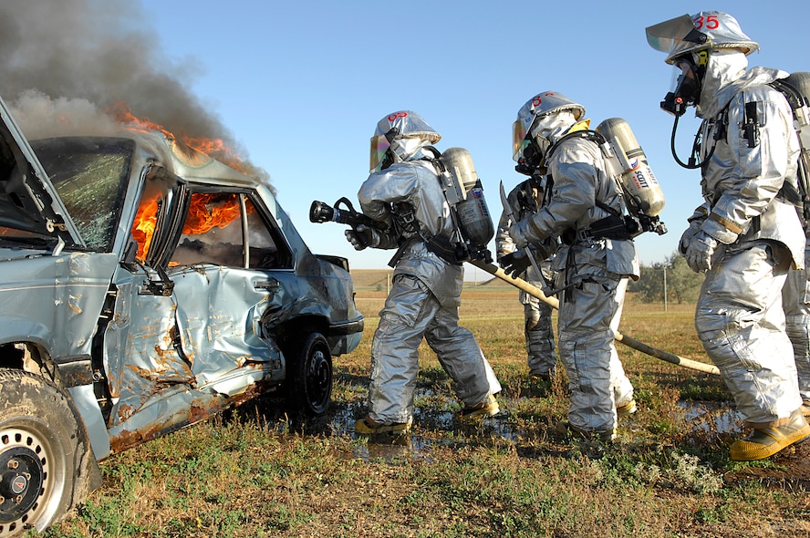 MINOT AIR FORCE BASE, N.D. -- Fire Fighters from the 5th Civil Engineer Squadron here complete their semi-annual automobile fire extinguishing training using a donated car, Oct. 1. (U.S. Air Force photo by Senior Airman Kelly Timney)