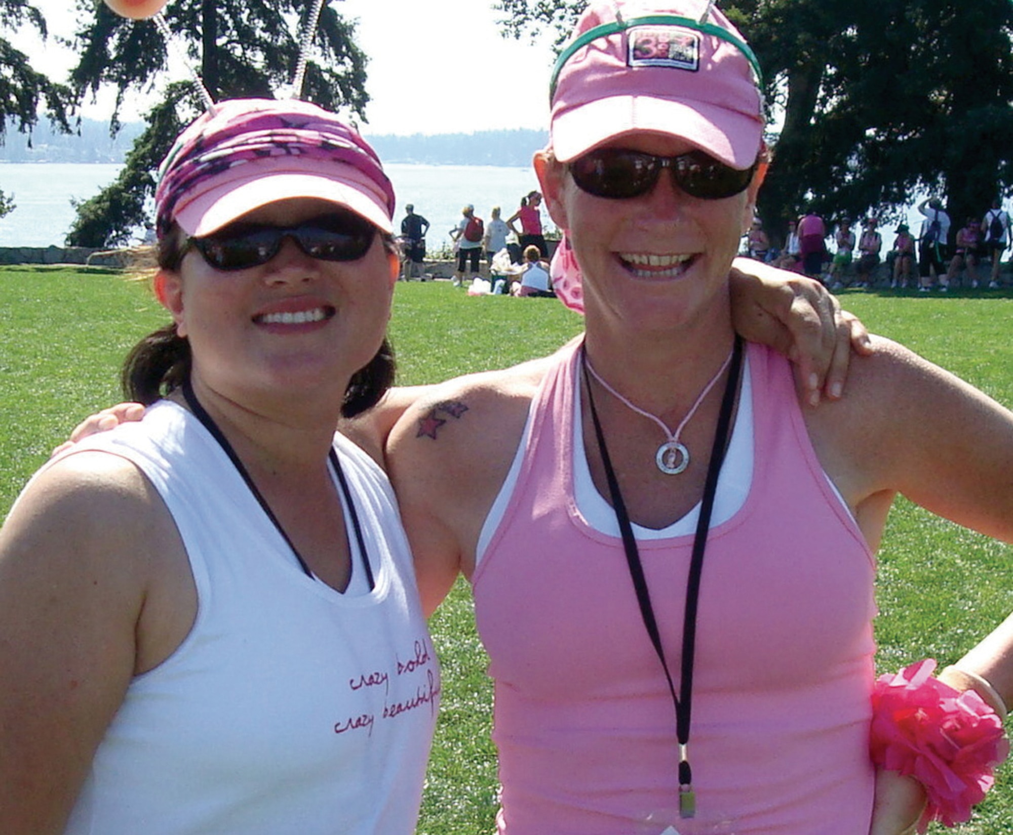 Master Sgt. Diana Feeley (left) and Master Sgt. Chrisandra Davis, a breast cancer survivor, smile for the camera Sept. 13 during a rest in their 60-mile walk.  Sergeant Feeley, an Air Force Reservist, and Sergeant Davis, and active-duty Airman, were a Total Force team that completed the Susan G. Komen Breast Cancer 3-Day, an event to raise money for breast cancer research.  Sergeant Feeley is a client support administrator for the 446th Airlift Wing and  Sergeant Davis is a CSA with the 62nd Operations Group, both at McChord Air Force Base, Wash. (Courtesy photo)