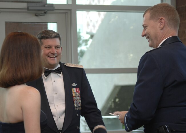 Lt. Gen. Vern "Rusty" Findley, center, speaks with Col. John "Red" Millander and his wife Deb before the annual Air Force Ball held at the North Charleston Convention Center Sept. 27. More than 850 Team Charleston members came together to celebrate the Air Force's 61st birthday. General Findley is the Air Mobility Command vice commander and Colonel Millander is the 437th Airlift Wing commander. (U.S. Air Force photo/Airman 1st Class Katie Gieratz)