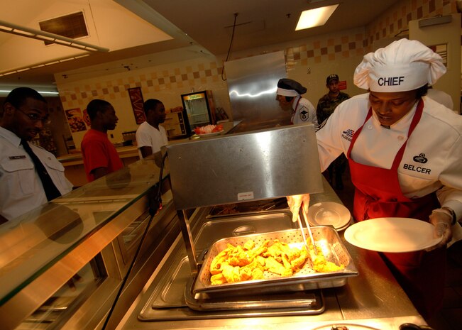 Chief Master Sgt. Bernise Belcer serves food to Charleston's Airmen during lunch at the Gaylor Dining Facility Sept. 29. Chief Belcer recalled serving food to Airmen at one of her past bases and feels it is important to interact and give back to Airmen as much as possible. Chief Belcer is the 437th Airlift Wing command chief master sergeant (U.S. Air Force photo/Airman 1st Class Timothy Taylor)