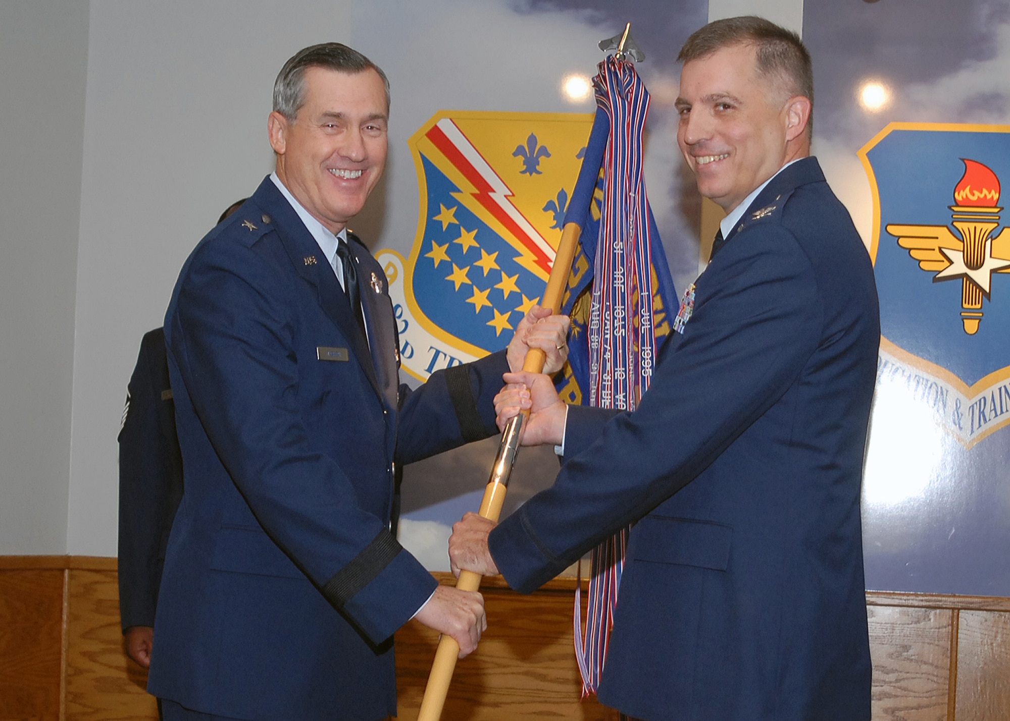 Brig. Gen. O.G. Mannon, 82nd Training Wing commander, passes off the guidon of the 982nd Training Group to its new commander, Col. John Rausch. Colonel Rausch accepted the command Sept. 30, replacing Col. David Norsworthy. Colonel Norsworthy now serves as the 82nd TRW vice commander. (U.S. Air Force photo/Lou Anne Sledge)