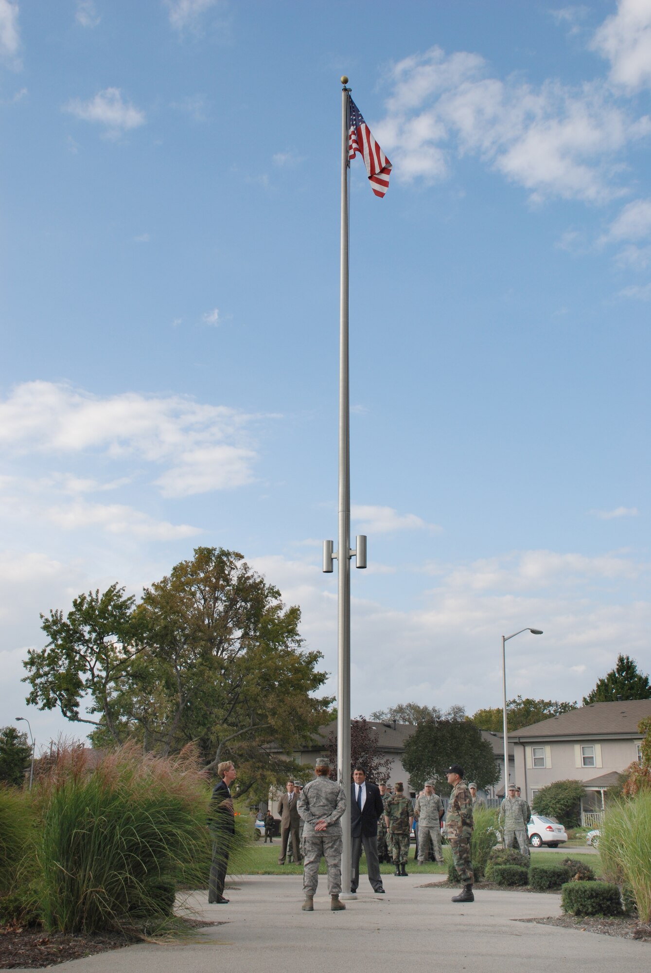 A four-member military-civilian flag detail prepares to lower the American flag at The Prairies at Wright Field on Sept. 30. Team members from left are Dr. Camilla A. Mauzy, Master Sergeant Julie A. Boyer, Dr. Nicholas J. DelRaso and Major Leamon K. Viveros . (U.S. Air Force photo/Chris Gulliford)