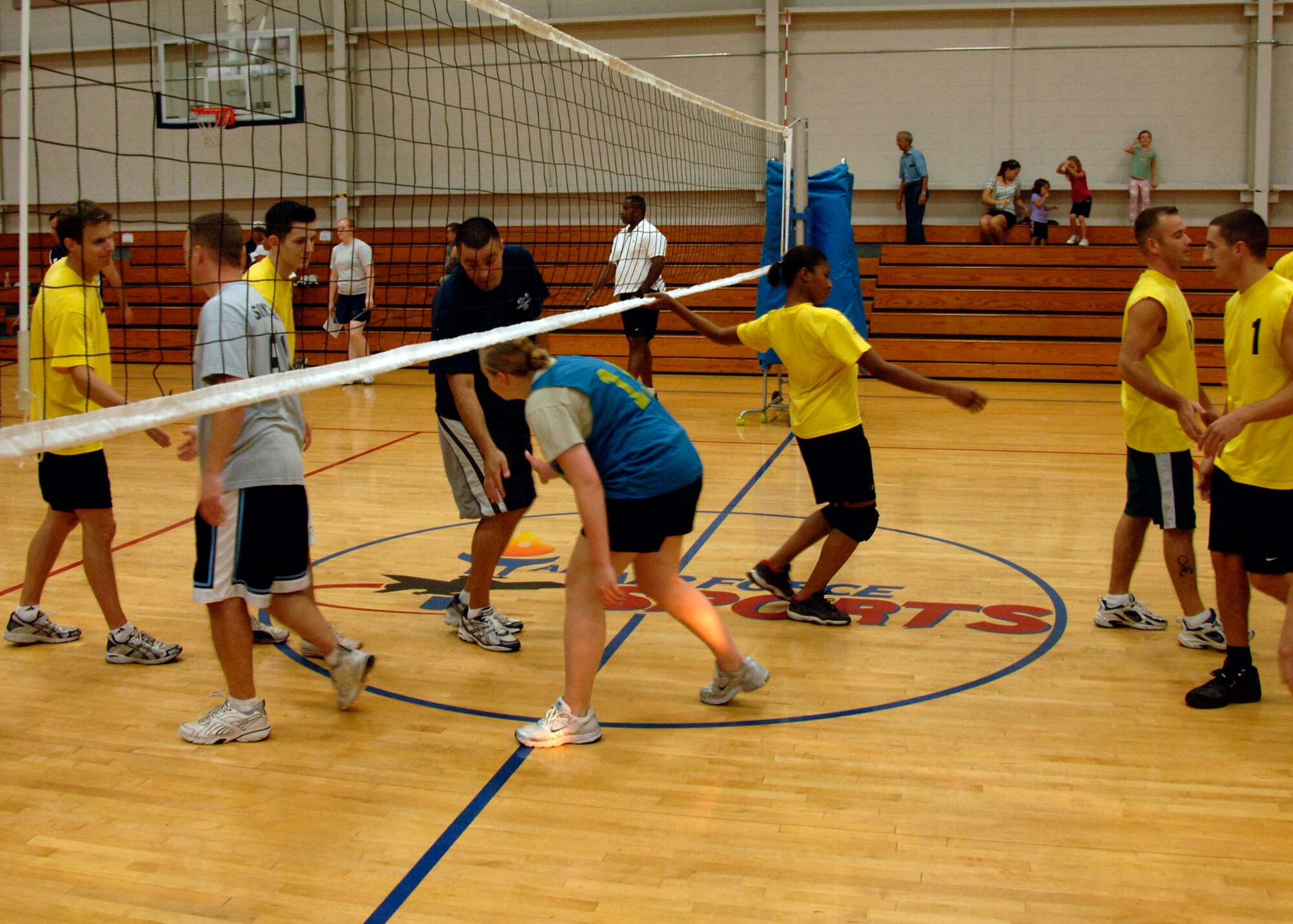 APS and COM shake hands and congratulate each other after a hard fought match of volley ball at the base fitness center Sept. 30. APS defeated COM 25-17 in two out of three games. (U.S. Air Force photo/Airman 1st Class Timothy Taylor)
