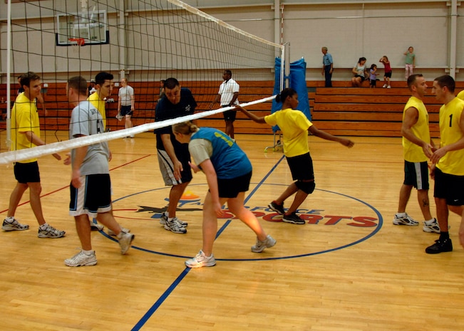 APS and COM shake hands and congratulate each other after a hard fought match of volley ball at the base fitness center Sept. 30. APS defeated COM 25-17 in two out of three games. (U.S. Air Force photo/Airman 1st Class Timothy Taylor)