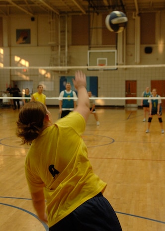 Megan Johnson serves during the first game against the Communications squadron at the base fitness center Sept. 30. Johnson is with the Aerial Port Squadron team. APS defeated COM 25-17 in two out of three games. (U.S. Air Force photo/Airman 1st Class Timothy Taylor)