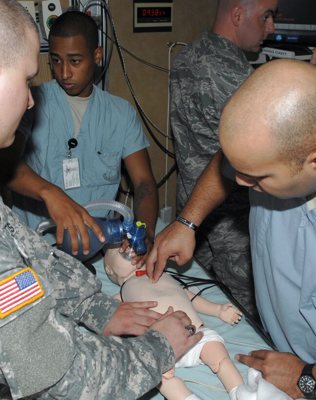 Medical residents use a mannequin to practice reviving an infant in the simulation center at Wilford Hall Medical Center on Lackland Air Force Base, Texas. The training is designed to replicate the stressful situations medics will encounter when treating patients.  The simulation center is routinely used by both Air Force and Army medical residents training in a wide variety of specialties including pediatric intensive care. (U.S. Air Force photo/Senior Airman Robert Barnett)