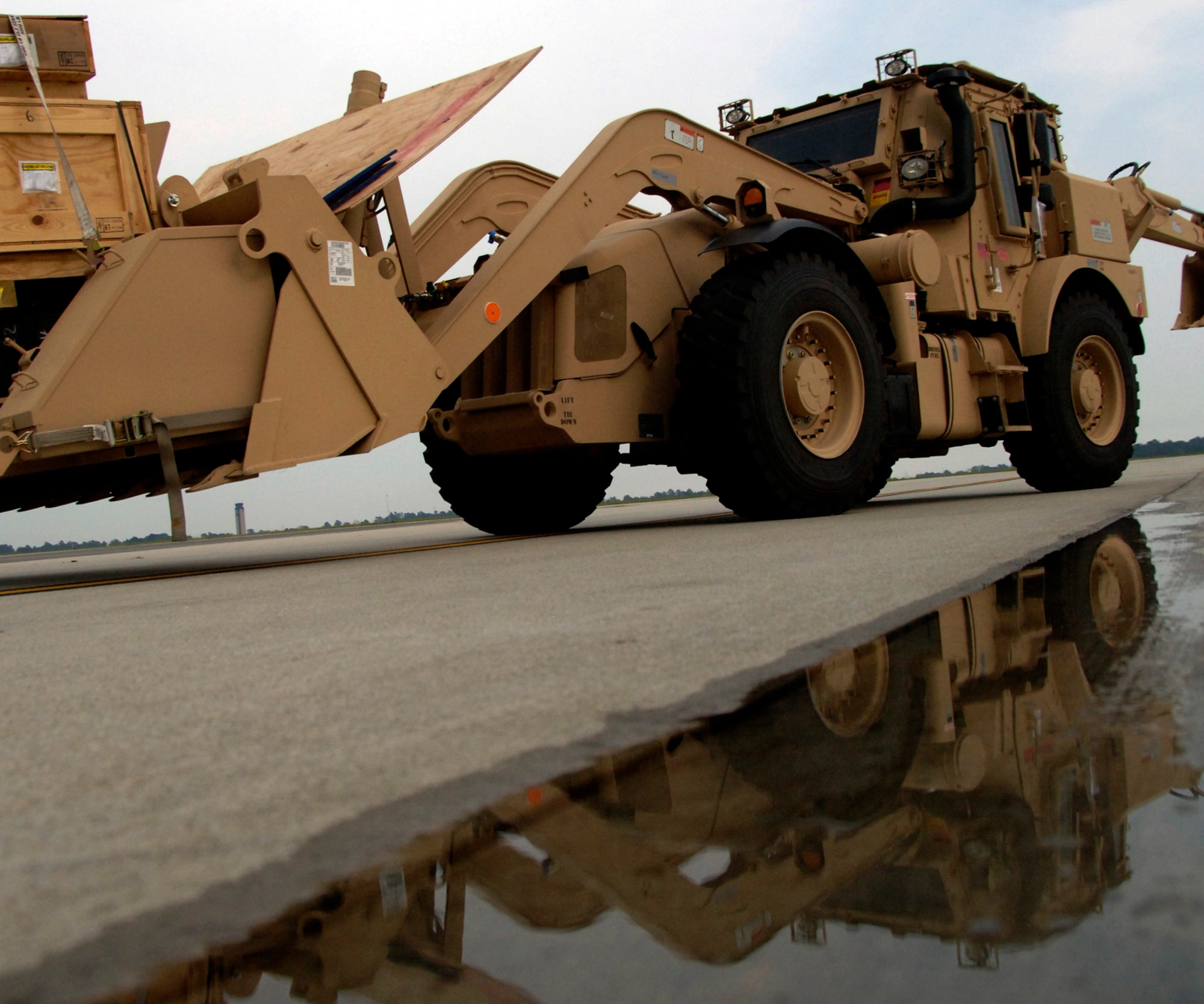 An HMEE is moved into position prior to being loaded onto a C-5 on Charleston AFB flightline Sept. 29. The HMEEs will be transported to forward deployed locations to assist Soldiers and contractors in hostile environments. Airman Parsons an air transportation journeyman with the 437th Aerial Port Squadron.  (U.S. Air Force photo/Airman 1st Class Timothy Taylor)

