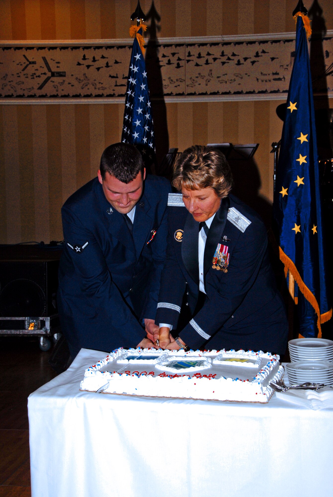ELMENDORF AIR FORCE BASE, Alaska -- Brig. Gen. Michelle Johnson, Deputy Director for Global Effects and the War on Terrorism for the Joint Staff, and Airman Joshua Petteway, 3rd Component Maintenance Squadron, cut the traditional cake at a celebration marking the 61st birthday of the U.S. Air Force. (U.S. Air Force photo/Tech Sgt. Jeremiah Erickson)
