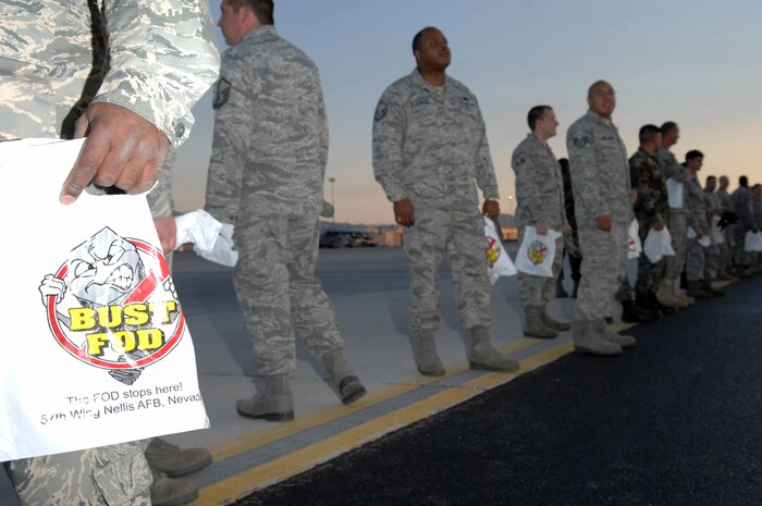 NELLIS AIR FORCE BASE, Nev. -- Airmen assigned to the 57th Wing prepare to walk the base runway in search of foreign object debris (FOD) that could potentially damage Air Force aircraft assets, on Sept. 30, 2008. (U.S. Air Force Photo by/Senior Airman Larry E. Reid Jr.)