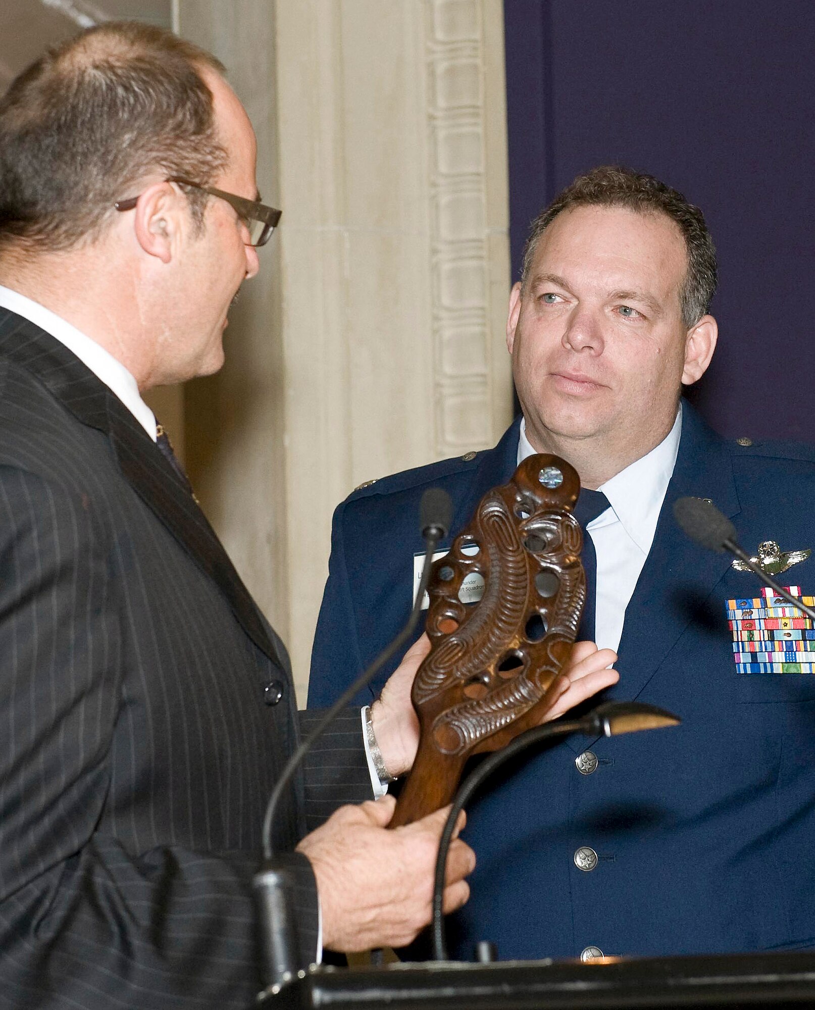 Lou Sanson, Antarctica New Zealand chief executive, presents Lt. Col. Jim McGann with a traditional Maori chief's weapon known as a Patu during a ceremony in Christchurch, New Zealand, Sept. 26. Colonel McGann, who leads C-17 Globemaster III operations in support of Operation Deep Freeze, was presented with the Christchurch Civic Award at the ceremony, becoming the first American to receive the honor. (Courtesy photo/Neil MacBeth)