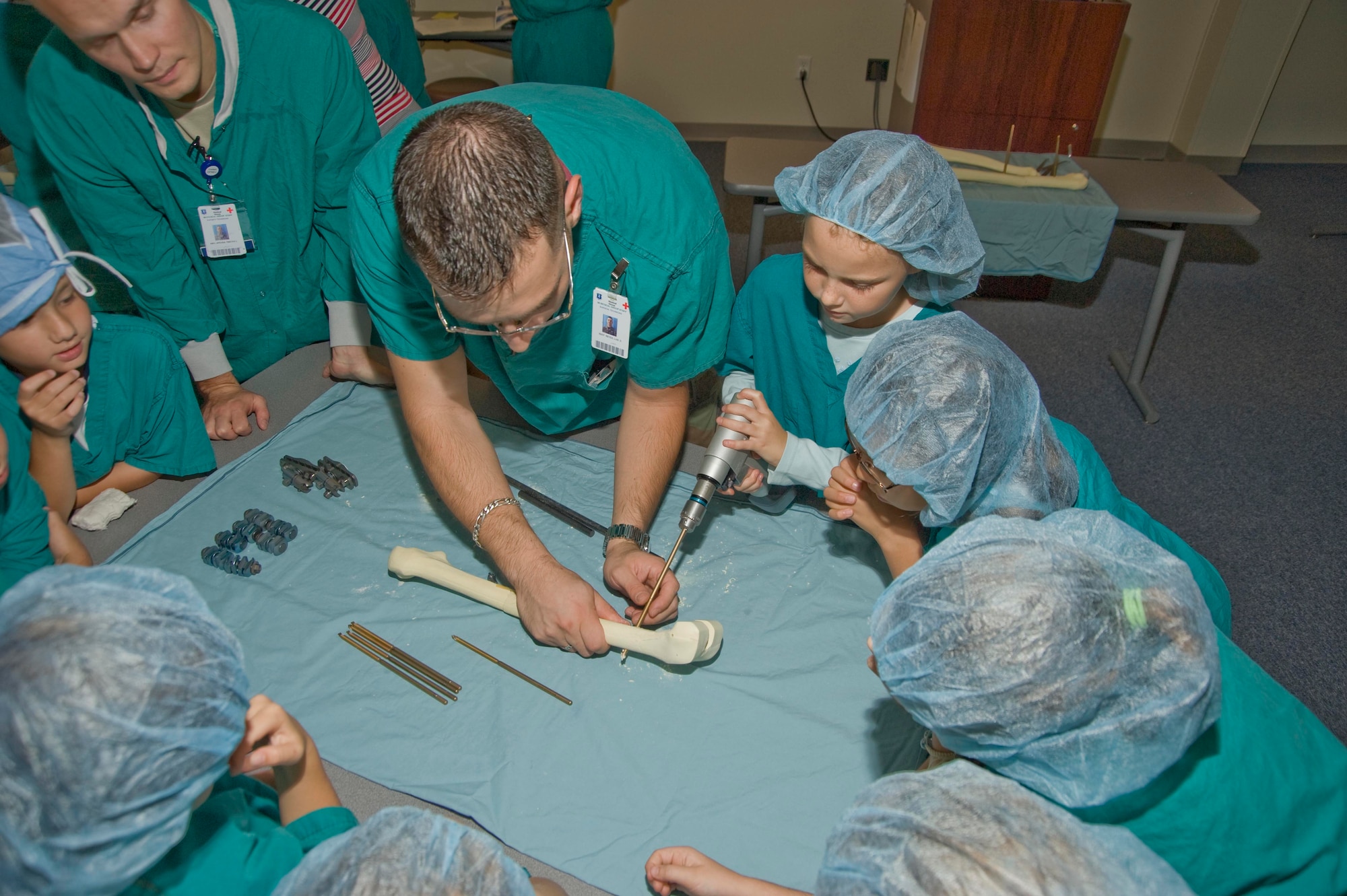 EGLIN AIR FORCE BASE, Fla. -- Staff Sgt. Luis Reyes shows students orthopedic techniques while Airman Tim Japenga assists. The students from the Edge Elementary School's Gifted Program are studying Biomedical Engineering. (USAF photo by Greg Murry)