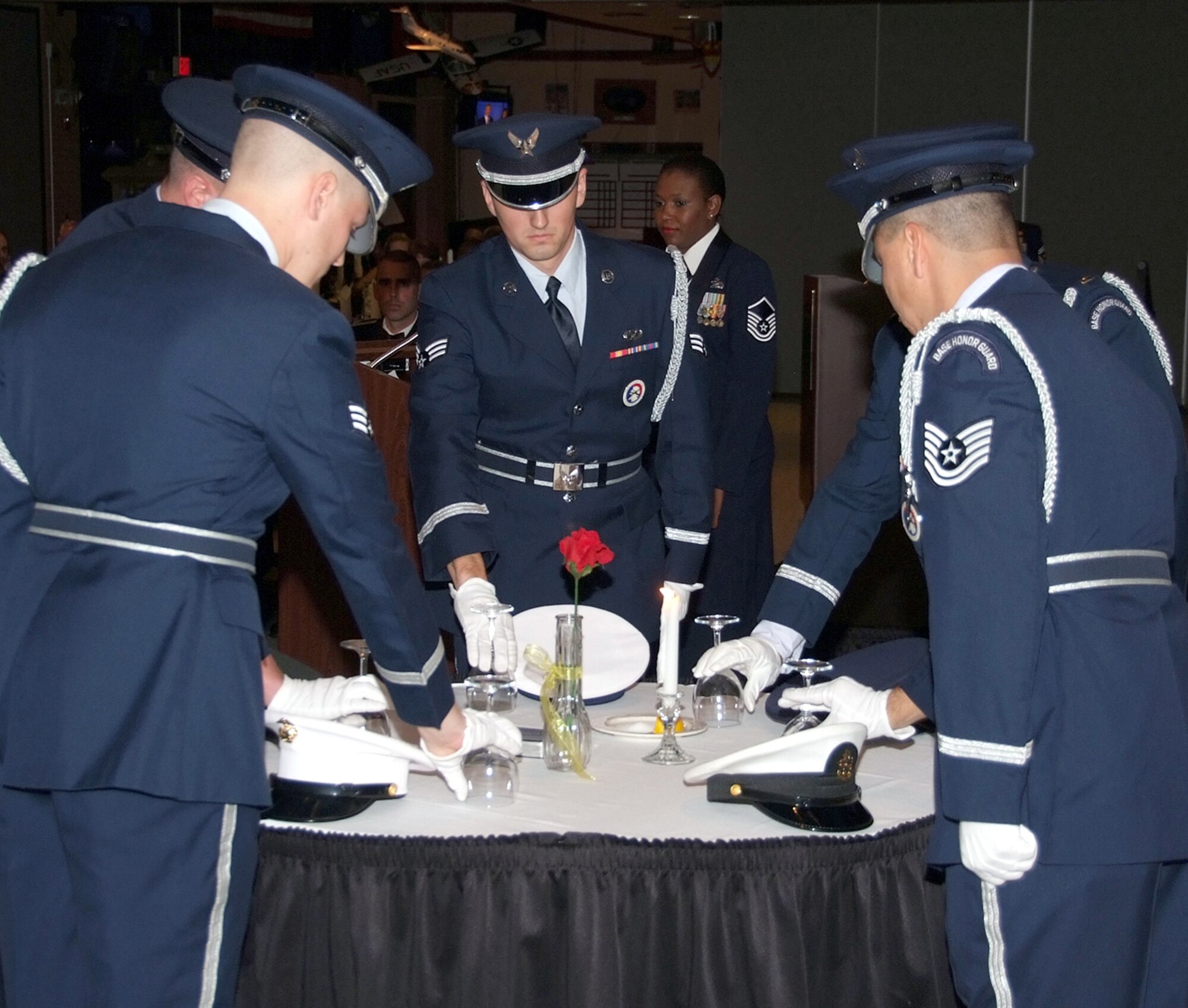 Members of the Silver Talon Honor Guard perform the POW/MIA ceremony at the Vance Senior NCO Induction ceremony held Sept. 24 in the Vance Collocated Club. Hats representing the Army, Air Force, Navy, Marines and Coast Guard were placed on the table and drinking glasses were inverted. (U.S. Air Force photo by Terry Wasson)