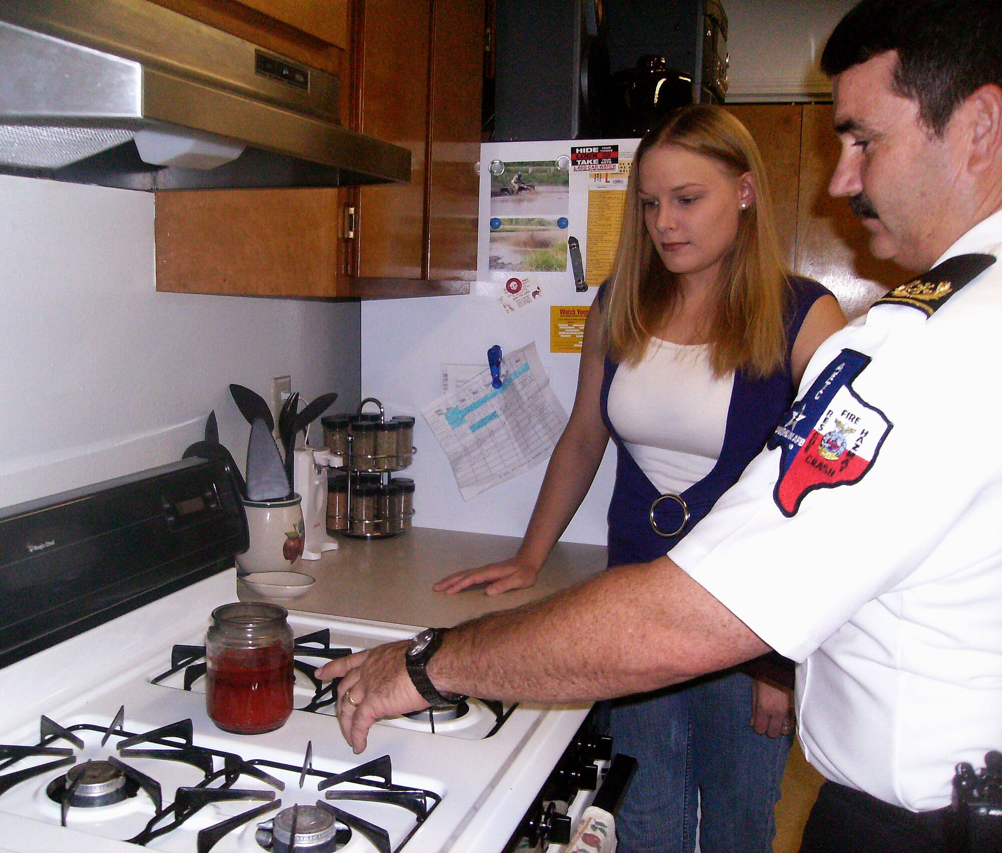 LAUGHLIN AIR FORCE BASE, Texas -- David Isbell, 47th Flying Training Wing fire department, demonstrates fire safety tips to Heather Martin at a Laughlin housing unit here recently. (contributed photo) 