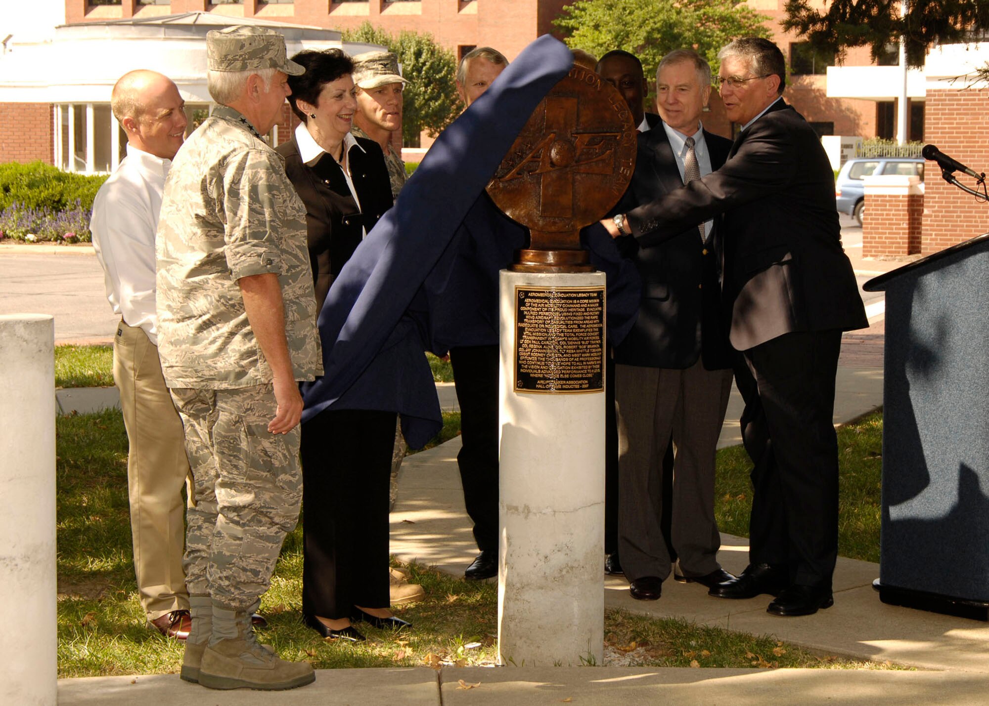 SCOTT AIR FORCE BASE, Ill. -- Gen. Arthur J. Lichte, Air Mobility Command commander, looks on as members of the Airlift/Tanker Association and Aeromedical Evacuation Legacy Team unveil a bust dedicated to the Aeromedical Evacuation mission at the "Walk of Fame" on Scott, Sept. 25. The Aeromedical Evacuation Mission is the first group inducted into the A/TA Hall of Fame. The ceremony was hosted by the A/TA's Huyser Chapter at Scott AFB. (U.S. Air Force photo/ Senior Airman Jonathan Lovelady)
