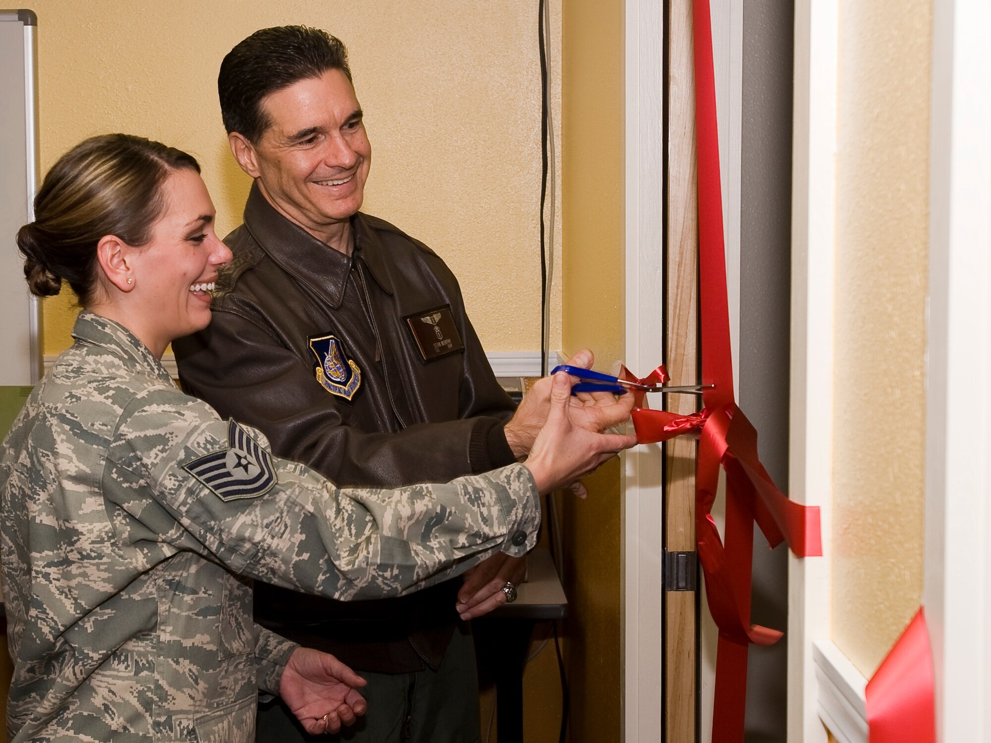 ELMENDORF AIR FORCE BASE Alaska -- Tech. Sgt. Amy Miller, 3rd Medical Group, and Col. Sean Murphy, Pacific Air Forces Surgeon General, cut the ribbon for the newly built simulation lab Sept. 30. The new lab will allow students to train on real-world scenarios ensuring that they are able to perform optimally in the field. (U.S. Air Force photo/Staff Sgt. Joshua Garcia)