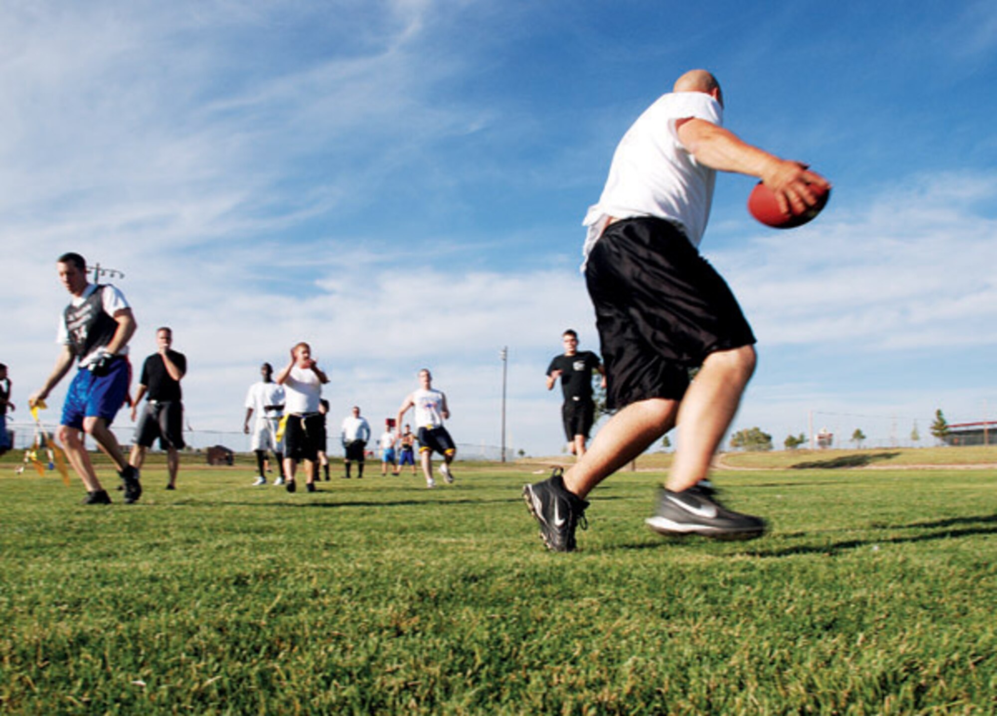 Travis Bowersock from the 90th Civil Engineer Squadron team barely crosses the goal line when a 90th Operation Group team member snatched Bowersock's flags during the flag football game Sept. 23 at the base football field. The 90th CES team won the game 27-0. (Photo by Airman 1st Class Daryl Knee)