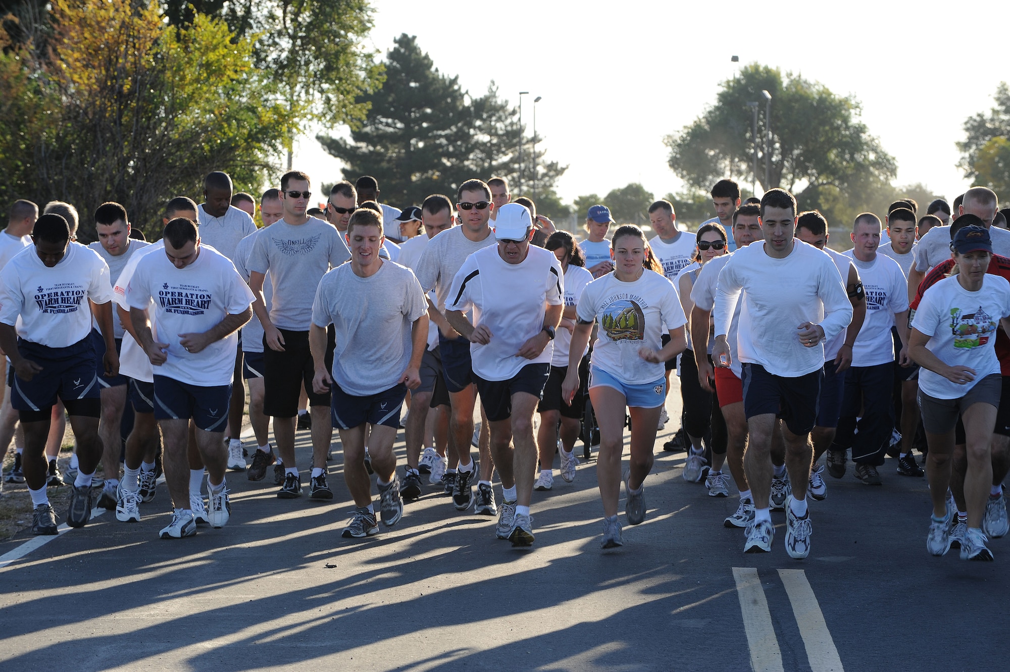 Team Buckley Members take off to start the Operation Warm Heart 5K run here Sept. 26. More than 70 people took part in the run to help raise donations for military families during the holidays. The Buckley First Sergeants Association, in conjunction with the 460th Space Wing Chapel, runs Operation Warm Heart. Donations are still being accepted. To make a donation, talk to a first sergeant any time of year. (Air Force photo by Airman 1st Class Christopher Bush.)