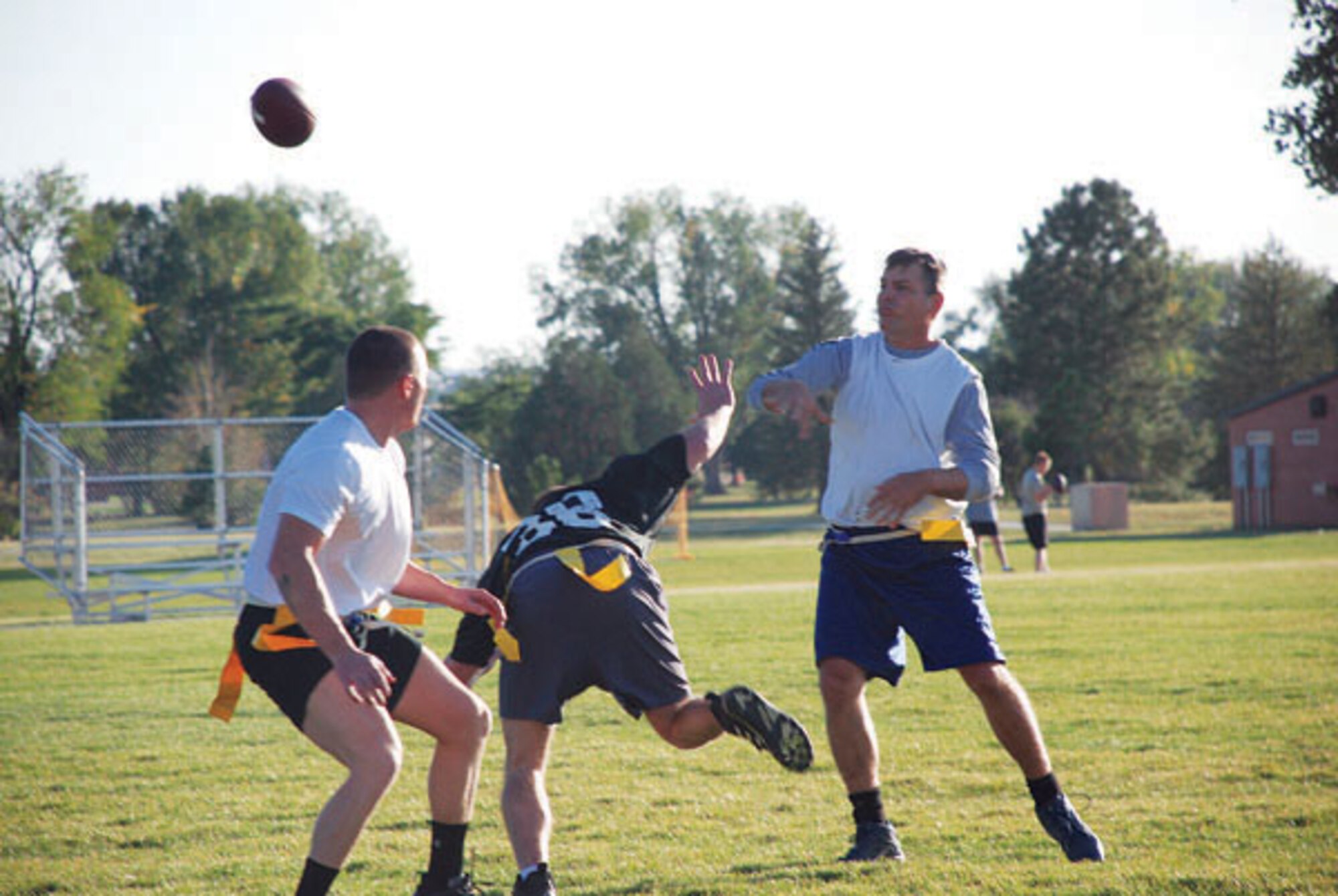Civil engineer quarter back Dan Conrad throws the football during the game Tuesday at the base football field as an operations group member tries to swat the ball out of the air. The 90th CES team shut out the 90th Operations Group 27 to 0.  (Photos by Airman 1st Class Daryl Knee)