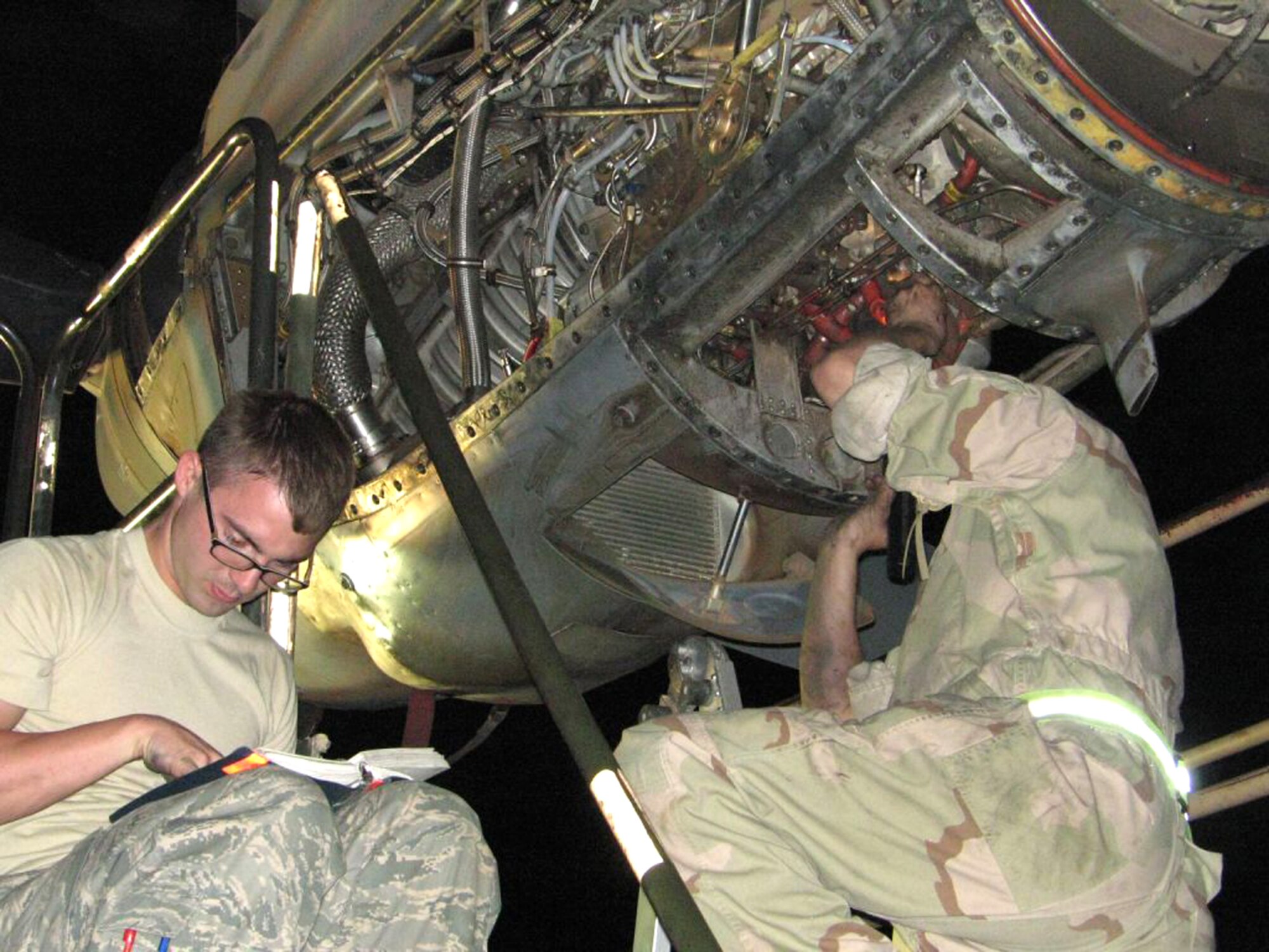Senior Airman Luke Johnson, left, 379th Expeditionary Aircraft Maintenance Squadron, and Tech. Sgt. Scott Roberts, 386th EAMXS, troubleshoot a C-130 Hercules engine issue at an air base in Southwest Asia. Engines technicians deployed to the U.S. Central Command area of responsibility perform maintenance actions while facing a variety of problems, including harsh weather conditions and dust.