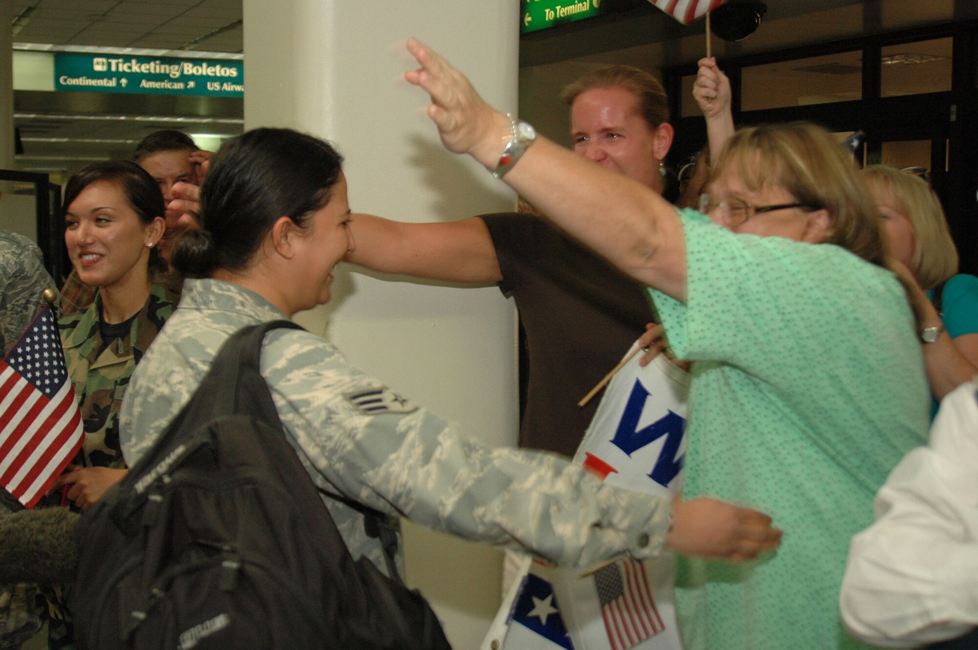 A member of the 433rd Civil Engineer Squadron is welcomed home after six months in Afghanistan Sept. 22 in San Antonio. Family and friends met them at the San Antonio Airport with banners and cheers. The Airmen built and repaired structures at Bagram Airfield, Afghanistan, and forward operating locations. They installed air-conditioning units for Soldiers and brought older buildings up to U.S. military construction codes. (U.S. Air Force photo/Master Sgt. Daniel Nathaniel) 