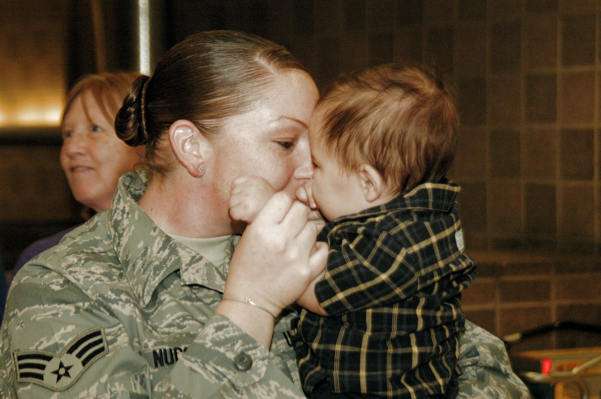 A member of the 433rd Civil Engineer Squadron gets a kiss from her son after spending six months in Afghanistan Sept. 22 in San Antonio. Family and friends met them at the San Antonio Airport with banners and cheers. The Airmen built and repaired structures at Bagram Airfield, Afghanistan, and forward operating locations. They installed air-conditioning units for Soldiers and brought older buildings up to U.S. military construction codes. (U.S. Air Force photo/Master Sgt. Daniel Nathaniel) 