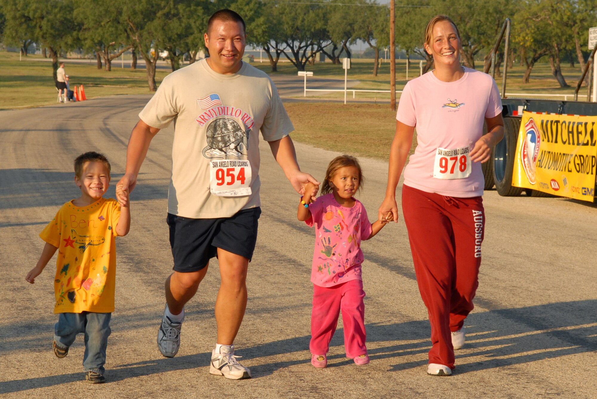 Holly Downs (right) and Army Staff Sgt. Lewis Nelson, 344th Military Intelligence Battalion Bravo Company instructor, and their children Benjamin and Arianna Nelson, finish the two mile individual race portion of the 2008 ArmyDillo Run at Mary E. Lee Park in San Angelo, Texas, Sept. 27.  More than 350 people participated in the annual event, which benefits the Sentinel Foundation and consists of a 10-kilometer race, a two-mile individual race, a two-mile team race, and a two-mile military formation race. (U.S. Air Force photo by Senior Airman Kasabyan Musal)