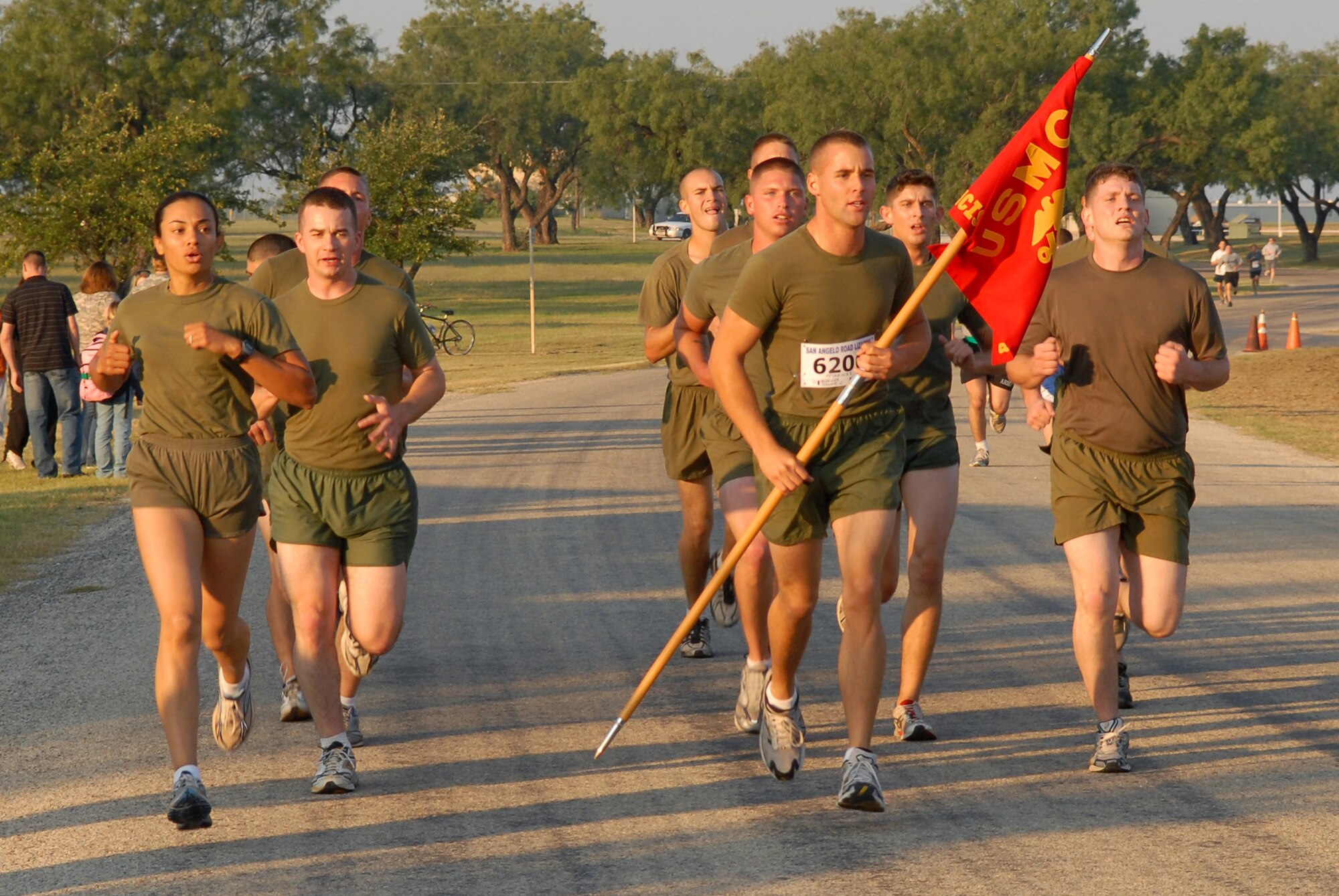 Marine Corps Detachment Goodfellow team members cross the finish line as the top finishers of the two mile military formation race portion of the 2008 ArmyDillo Run at Mary E. Lee Park in San Angelo, Texas, Sept. 27.  More than 350 people participated in the annual event, which benefits the Sentinel Foundation and consists of a 10-kilometer race, a two-mile individual race, a two-mile team race, and a two-mile military formation race. The MARDET team won the formation race with a time of 13:04. (U.S. Air Force photo by Senior Airman Kasabyan Musal)