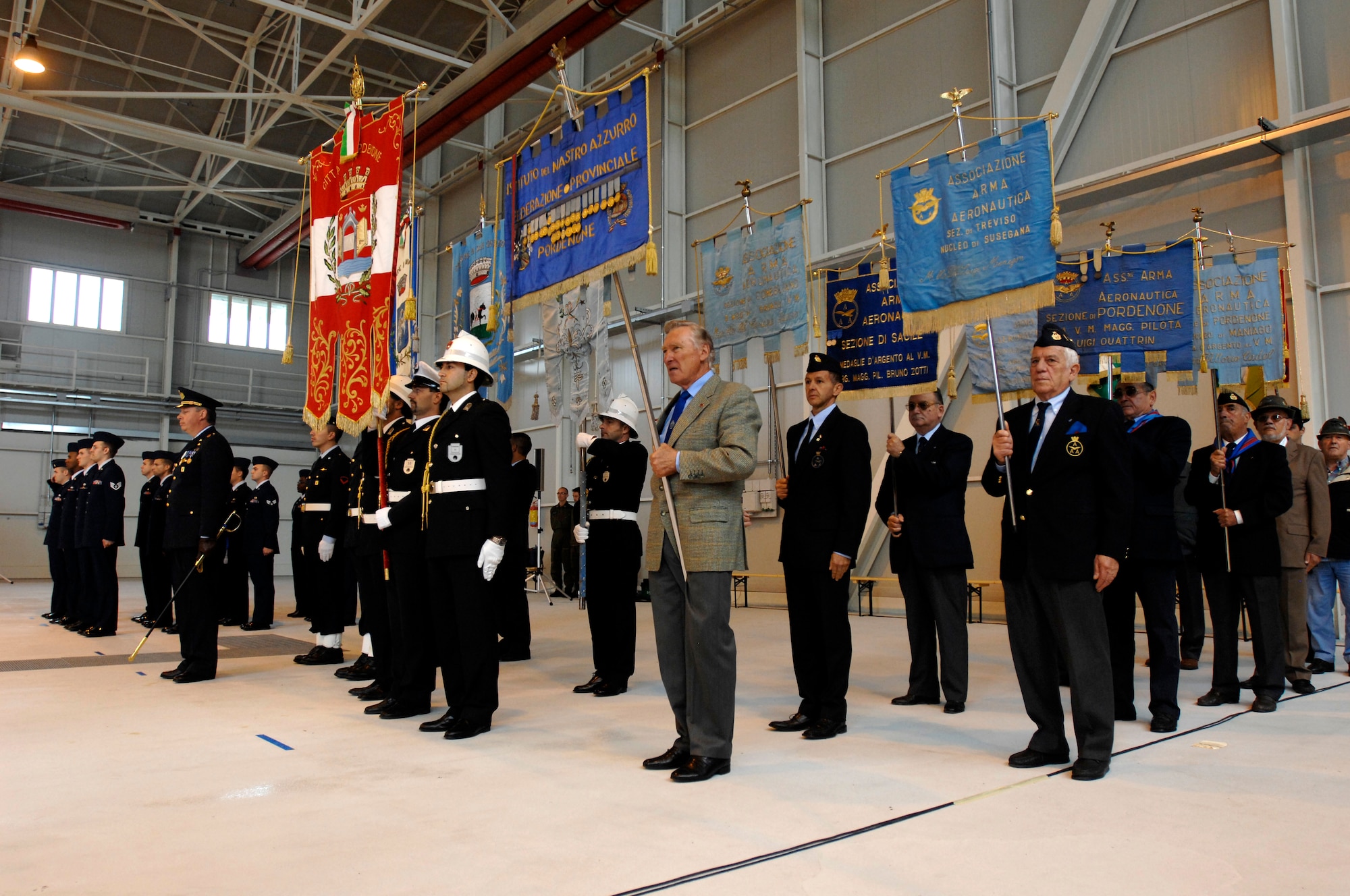 Representatives from various veterans associations in Friuli-Venezia Giulia hold guidons to represent their respective communities during the Italian Air Force "Pagliano e Gori" Airport change of command ceremony held Sept. 30 on Aviano Air Base. (U.S. Air Force photo/Airman 1st Class Ashley Wood) 