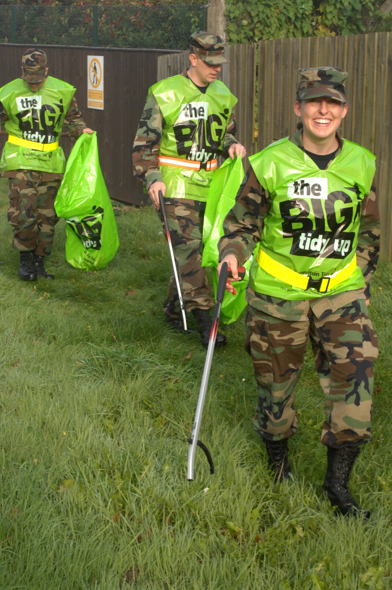 Staff Sgt.Tricia Williamson, Senior Airman Zachariah Viets and Staff Sgt. Matthew Ordorff, all 100th Operation Support Squadron Weather Flight, help pick up trash around the exterior periemter fence of RAF Mildenhall. Airmen from various squadrons around RAF Mildenhall took part in Britain's "Big Tidy Up" Sept. 26. The campaign was held throughout September and people were encouraged to participate in local clean-up events around the country, to reduce litter and improve the local environment. (U.S Air Force photo by Airman 1st Class Brad Smith)