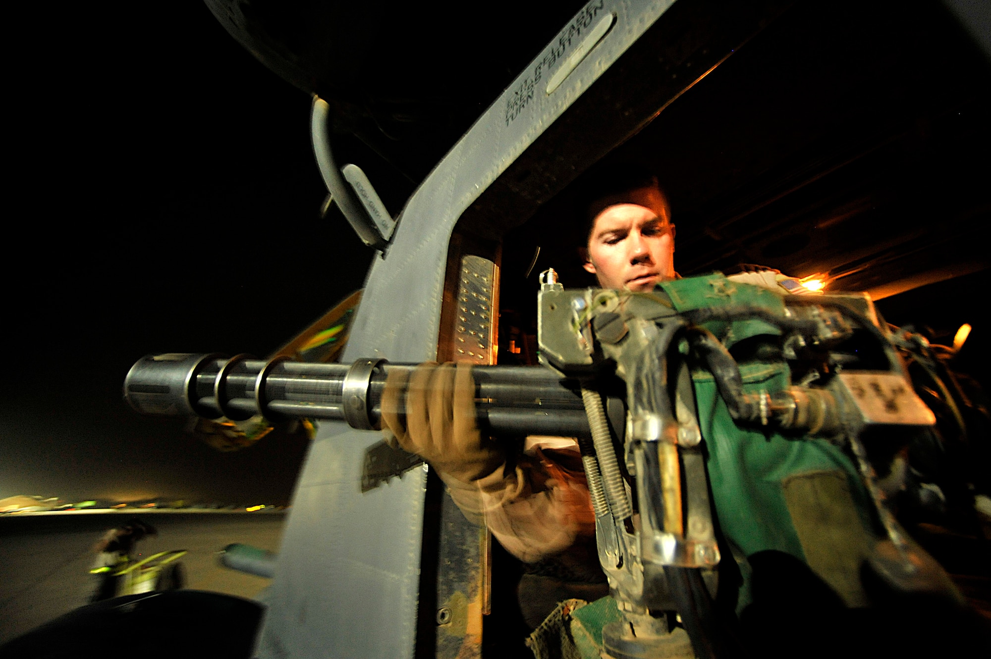 Tech. Sgt. Corey Fossbender checks a weapon gun prior to the last combat mission of the MH-53 Pave Low helicopter Sept. 27 in Iraq. The MH-53 is being retired after nearly 40 years of service to the Air Force. Sergeant Fossbender is an MH-53 aerial gunner from the 20th Expeditionary Special Operations Squadron. (U.S. Air Force photo/Staff Sgt. Aaron Allmon) 

