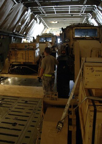 A  HMEE is positioned to the rear of a C-5 as aerial porters guide it through tight quarters of the aircraft on the Charleston AFB flightline Sept. 29. Aerial porters have to ensure there is equal weight distribution so aircraft do not experience difficulties taking off. (U.S. Air Force photo/Airman 1st Class Timothy Taylor)