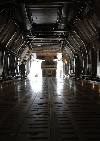 A HMEE is loaded onto a C-5 on the Charleston AFB flightline Sept. 29. The Air Force will be aiding in transporting the vehicles  to forward deployed Soldiers and contractors in hostile environments. The HMEE is a newly developed military construction vehicle capable of a wide range of mobility affording more protection for the operator than conventional excavators. (U.S. Air Force photo/Airman 1st Class Timothy Taylor)