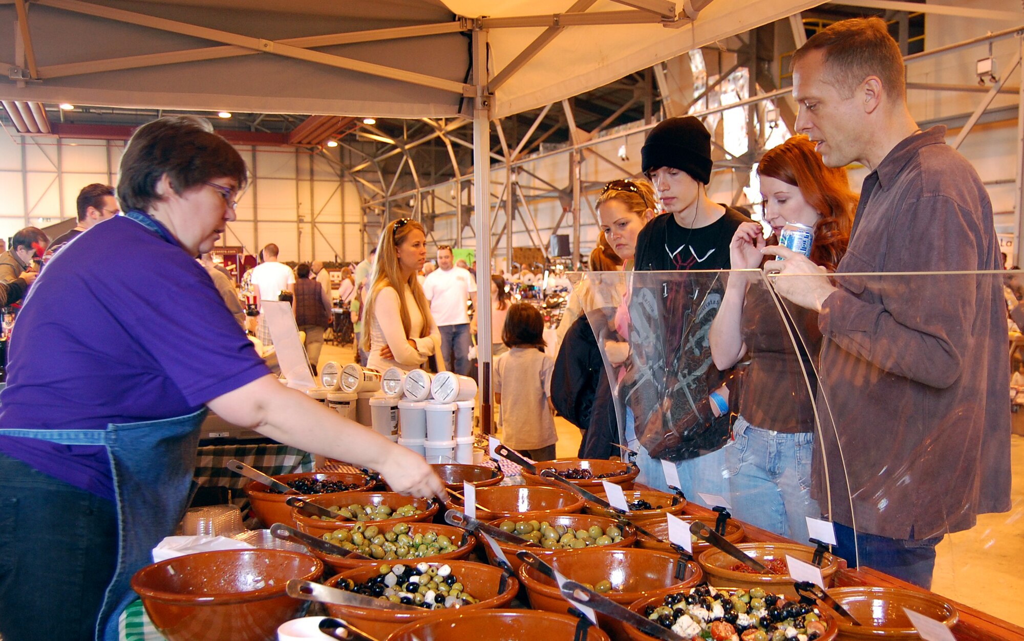 RAF Lakenheath shoppers sample the various food products sold by vendors from the local area during the base’s annual Holiday Bazaar, Sept. 26. More than 100 vendors attended the Bazaar Sept.  26 to 28. (Air Force photo by Senior Airman Stacy Sanchez)