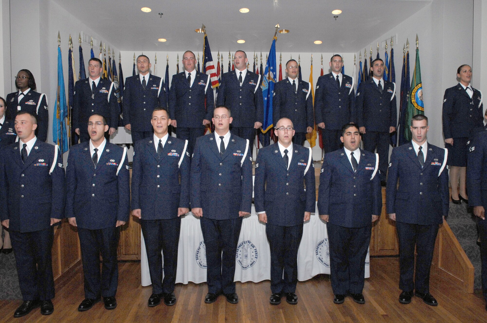 DYESS AIR FORCE BASE, Texas -- Class 08-G sings the Air Force Song to close the graduation ceremony of Airman Leadership School at the Heritage Club Sept. 25. ALS is an approximately five week-long Air Force program designed to develop Airmen into effective front-line supervisors.  It is the first professional military education that enlisted Air Force members encounter.  ALS focuses on developing leadership abilities as well as effective communication.   (U.S. Air Force photo by Staff Sgt Connor Estes).  
