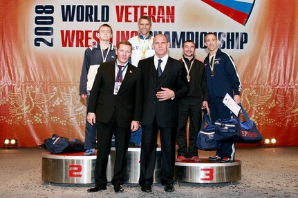 Steve Horton (right), a master sergeant with the 12th Flying Training Wing Public Affairs office, joins wrestler Stanislav Sludkin of Russia (from left to right), a member of the Russian Parliament, wrestler Alexander Smirnov of Russia, Alexander Karelin, three-time Olympic wrestling champion and Russian Parliament member, and Valentin Borisov of Russia at the 2008 World Veteran Wrestling Championship awards ceremony Sept. 26 in Perm, Russia. (Courtesy photo)