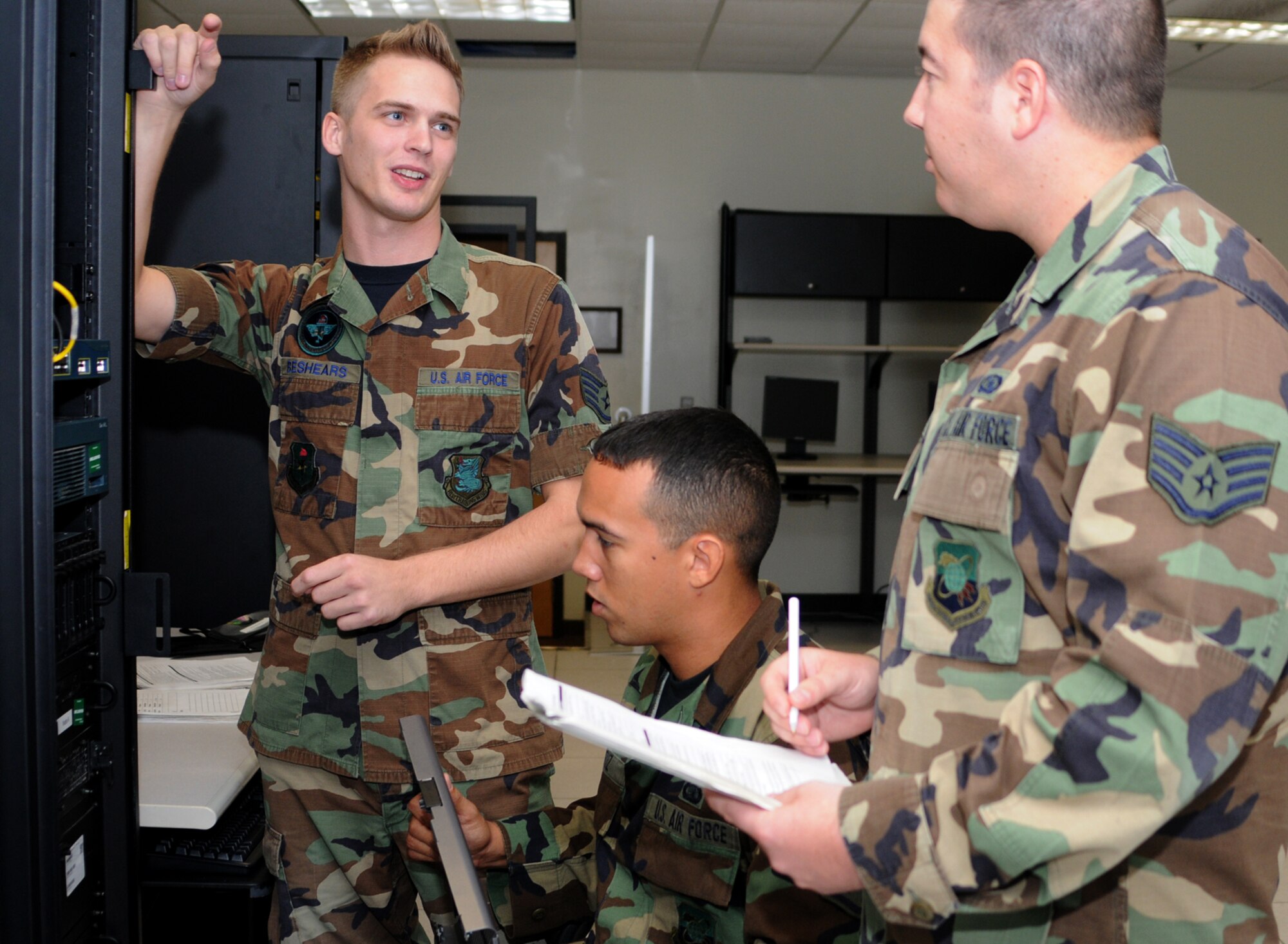 From left, Sergeant Beshears and Staff Sgts. Carlos Cruz and Adam Sargent review theatre battle management course systems in Stennis Hall.  All three are instructors in the 333rd TRS.  (U.S. Air Force photo by Kemberly Groue)