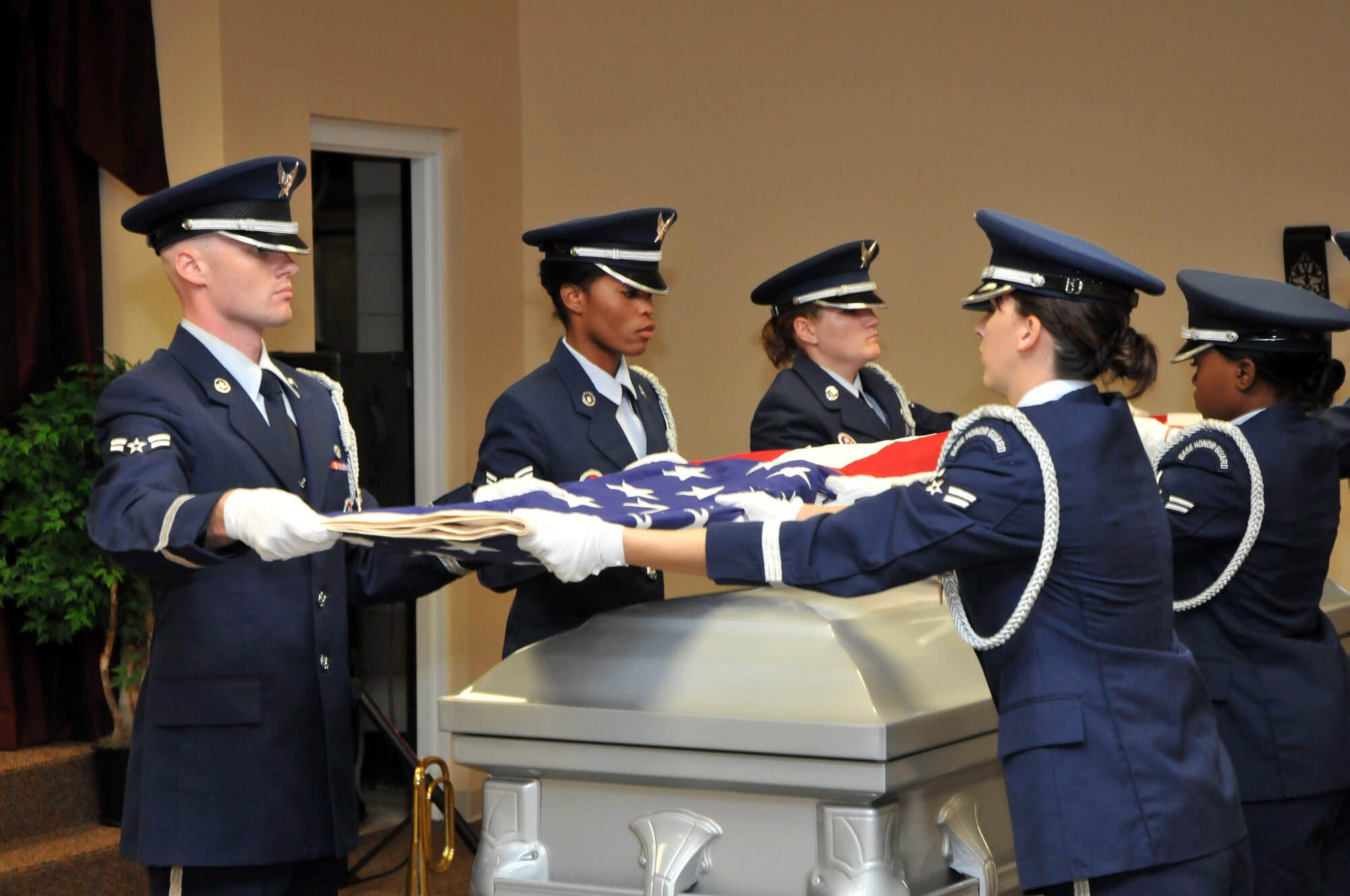 From left, Airmen 1st Class Matthew Proctor and Ras-hedia Robinson, Senior Airman Ashley LeDuc and Airmen 1st Class Katie Stanek and Stephanie Wil-liams demonstrate flag-folding procedures during Friday’s certification ceremony.  Airman Proctor is from the 85th Engineering Installation Squadron, Air-man Robinson from the 81st Training Wing,  Airman LeDuc from the 81st Force Support Squadron, Airman Stanek from the 81st Logistics Readi-ness Squadron, and Airman Williams from the 81st Communications Squadron.  (U.S. Air Force photo by Adam Bond)