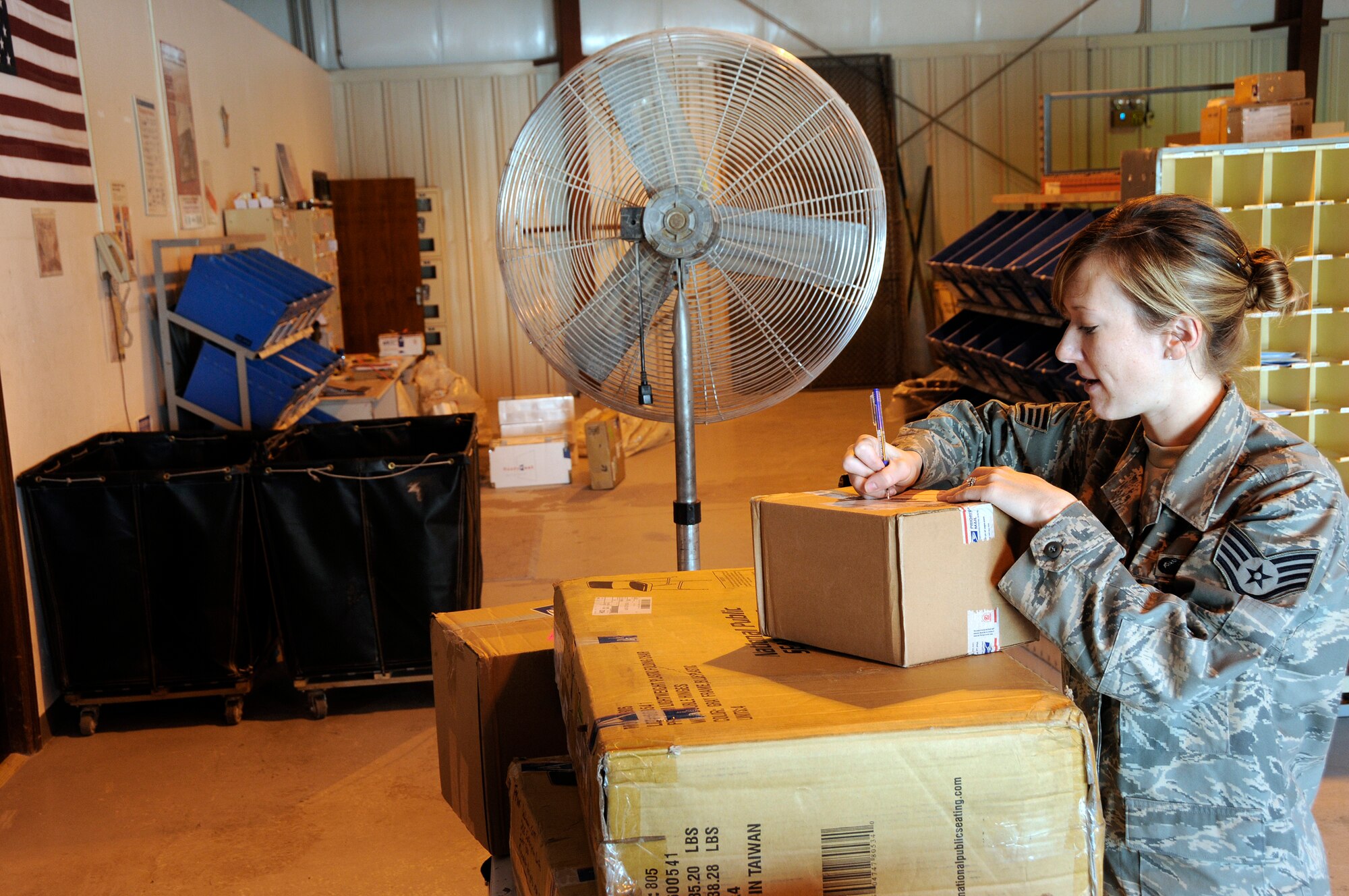 Staff Sergeant Bethany McClain, 379th Expeditionary Contracting Squadron, signs for accountable mail Sept. 30, 2008, at an undisclosed air base in Southwest Asia.  Unit mail clerks, an additional duty, make a daily run to pick up incoming mail and packages for their squadrons.  Sergeant McClain is a native of Safford, Ariz., and is deployed from Barksdale, La., in support of Operations Iraqi and Enduring Freedom and Joint Task Force-Horn of Africa.  (U.S. Air Force photo by Tech. Sgt. Michael Boquette/Released)