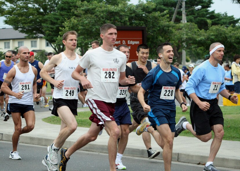 MISAWA AIR BASE, Japan -- Runners from the 2nd annual Misawa Flyer Race, jog by Edgren High School , Sept. 20, 2008. Running events, such as this, help build camaraderie and keep military members physically fit.  (U.S. Air Force photo by Senior Airman Chad Strohmeyer)