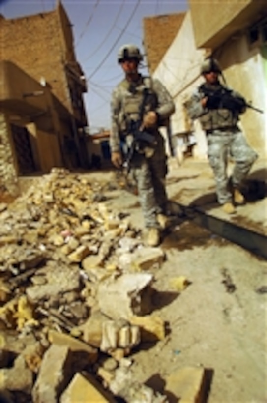 U.S. Army Sgt. Michael Blackert and Sgt. William Garett provide security with other soldiers in their platoon for a visiting dignitary inspecting the marketplace in Mahmudiyah, Iraq, on Sept. 17, 2008.  Blackert and Garett are assigned to Alpha Battery, 3rd Battalion, 320th Field Artillery, 101st Airborne Division.  