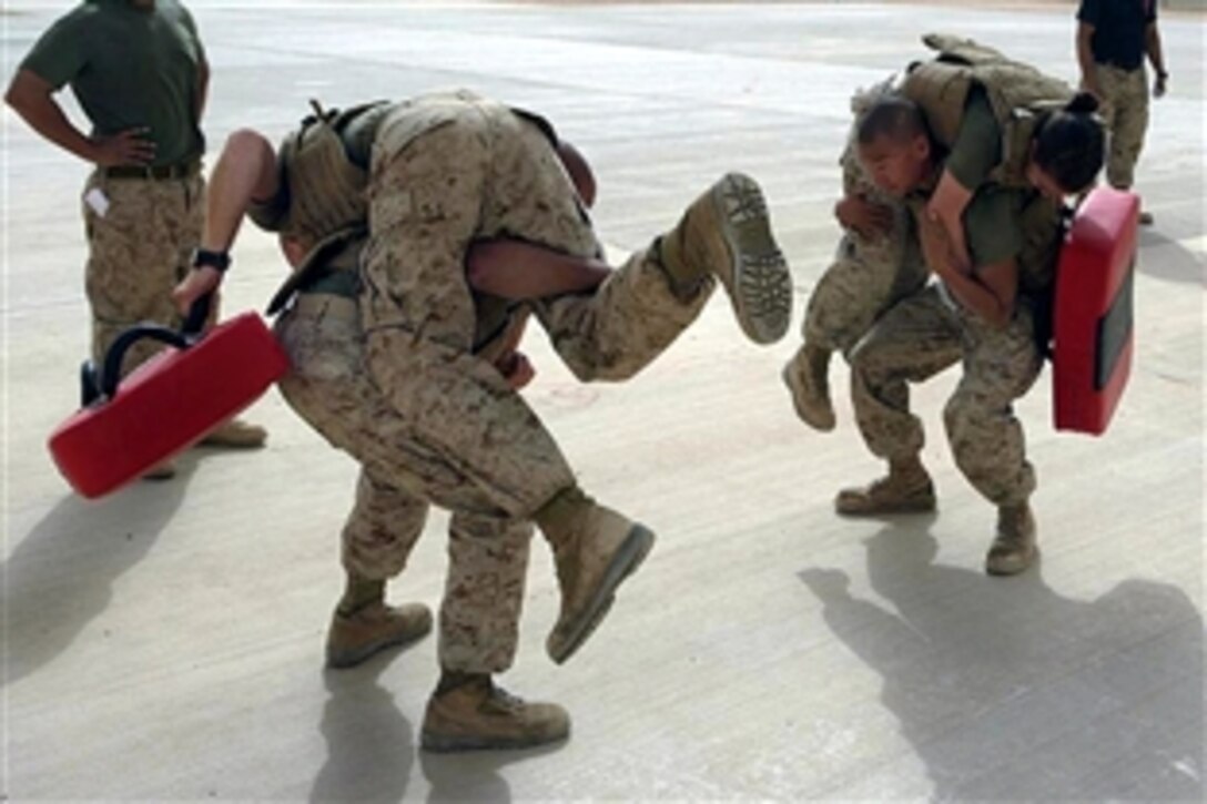 U.S. Marines execute squats with their partners while participating in a Marine Corps Martial Arts Program grey belt course on Asad Air Base, Anbar province, Iraq, Sept. 24, 2008. The Marines are assigned to the Marine Heavy Helicopter Squadron 462.