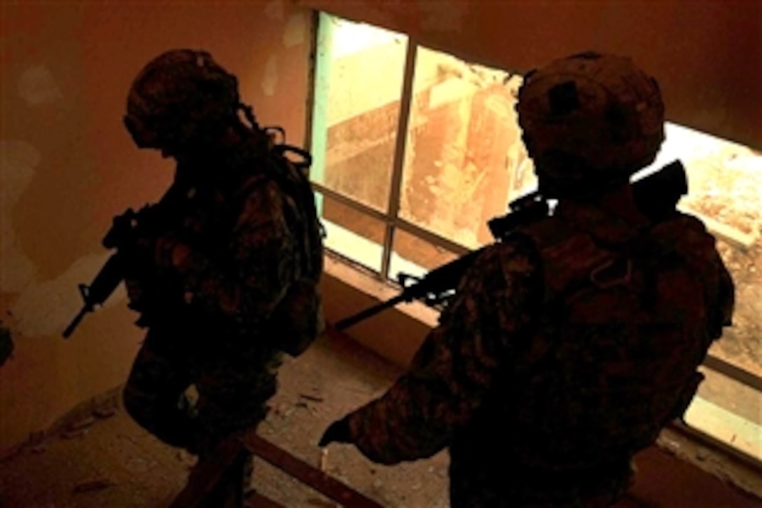 U.S. Army soldiers descend the stairs of a school during a patrol in the Sadr City district of Baghdad, Iraq, Sept. 27, 2008. The soldiers are assigned to the 4th Infantry Division's Personal Security Detail.

