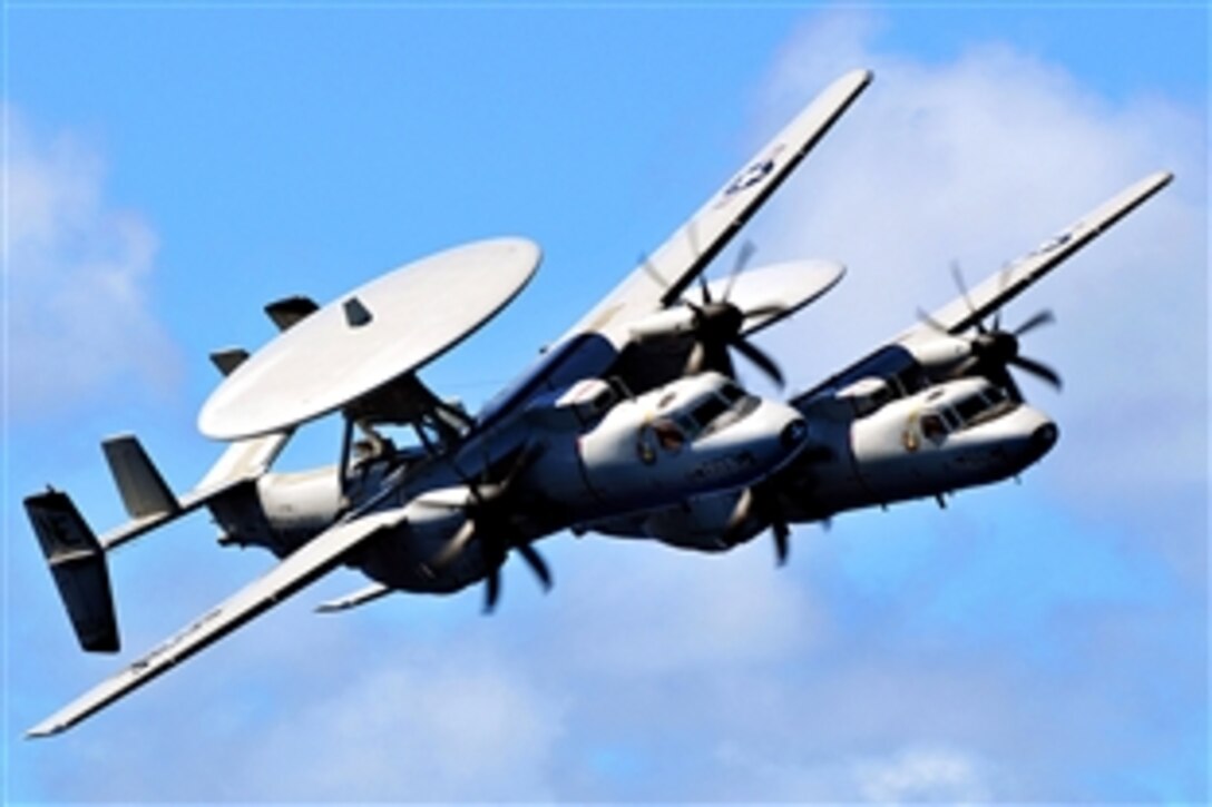 A pair of E-2C Hawkeyes assigned to the "Sun Kings" of Airborne Early Warning Squadron 116 pass over the aircraft carrier USS Abraham Lincoln during an air power demonstration performed by aircraft from Carrier Air Wing 2, Pacific Ocean, Sept. 29, 2008.