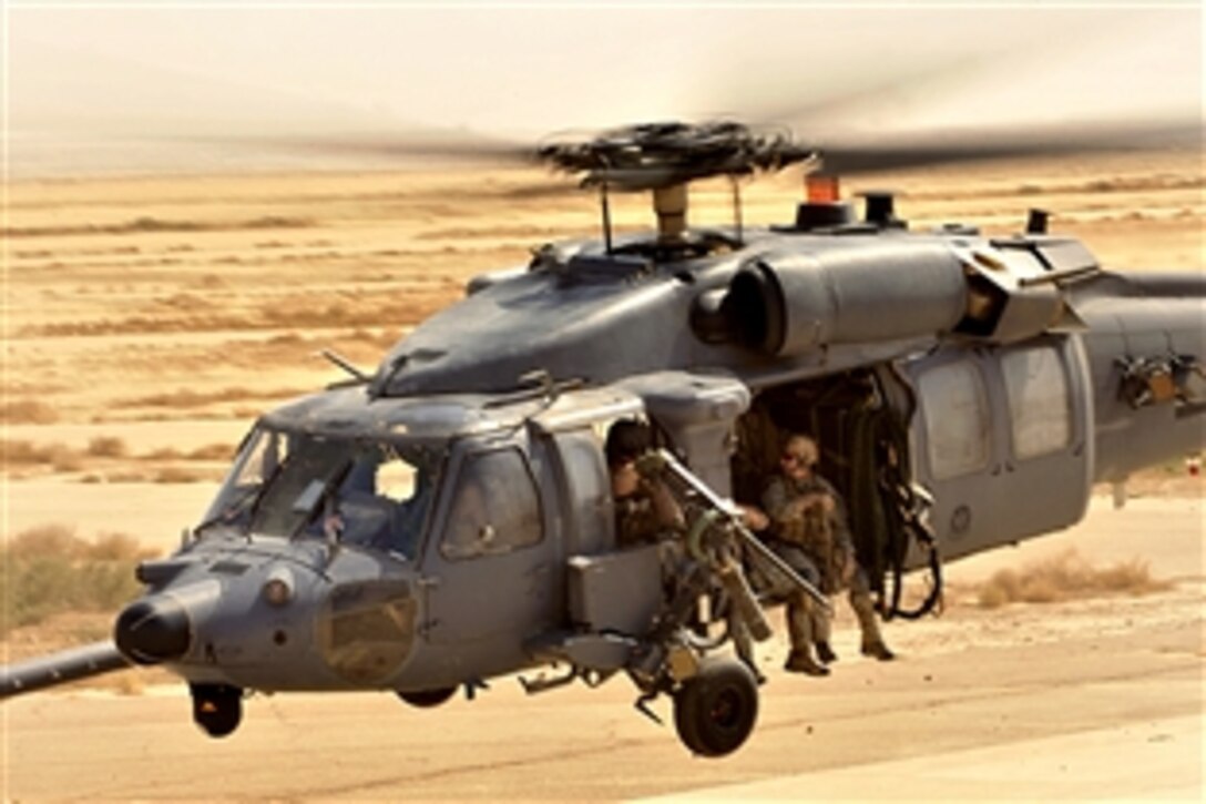 U.S. Air Force pararescuemen assigned to the 66th Expeditionary Rescue Squadron aboard a HH-60G Pave Hawk conduct operational training on Joint Base Balad, Iraq, Sept. 19, 2008

