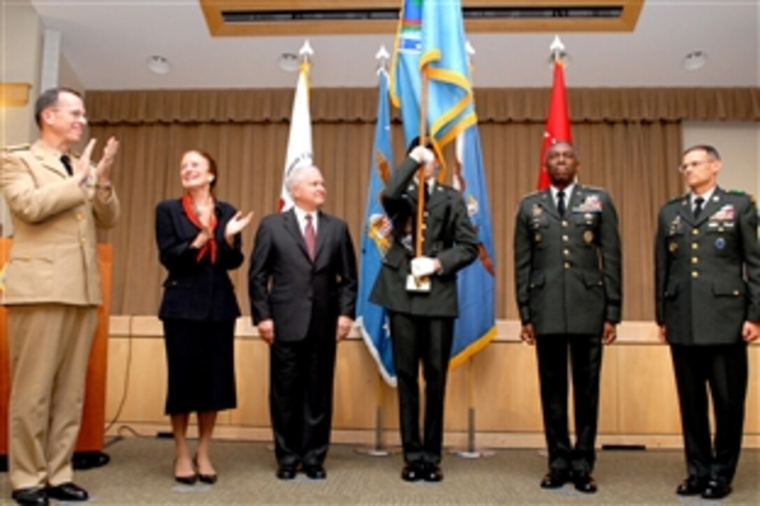 Left to right: Navy Adm. Mike Mullen, chairman of the Joint Chiefs of Staff; Henrietta H. Fore, administrator of USAID and director of U.S. Foreign Assistance; Defense Secretary Robert M. Gates; a flag bearer; Army Gen. William E. Ward, commander of U.S. Africa Command; and Army Command Sgt. Maj. Mark S. Ripka, the command's senior enlisted servicemember, stand together after the unfolding of the flag during the command's activation ceremony in the Pentagon, Oct. 1, 2008.