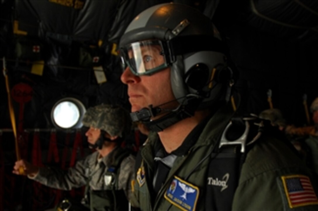 A U.S. Air Force pararescueman looks out the back of a C-130 Hercules aircraft prior to executing a jump over southwestern Germany on Sept. 24, 2008.  Pararescuemen conducted the jump in conjunction with airmen assigned to the 786th Security Forces Squadron in preparation for an upcoming mission in Bitburg, Germany.  