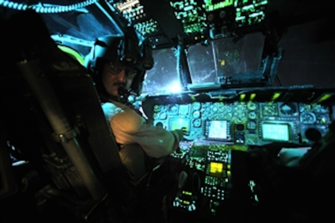 A U.S. Air Force pilot from the 20th Expeditionary Special Operations Squadron conducts a pre-flight check of an MH-53 Pave Low helicopter prior to the final combat mission at Joint Base Balad, Iraq, on Sept. 27, 2008.  The Pave Low is being retired after nearly forty years of service to the Air Force.  