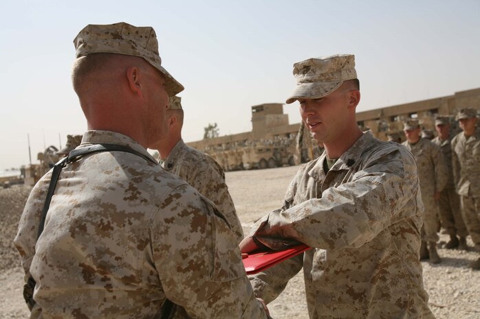 Sgt. Samuel R. Lott, a 23-year-old motor transportation operator from Mojave Valley, Ariz., with Headquarters and Support Company, Regimental Combat Team 1, receives his promotion warrant Oct. 1 at Camp Ramadi, Iraq. Lott was first deployed to Fallujah for a year in February of 2004 with RCT-1, then again with the unit to the same area of operations in January of 2008. As one of the few Marines in his platoon to deploy to al Anbar Province before, Lott quickly was looked to as a leader by both Marines his junior and his senior. (Official U.S. Marine Corps photo by Cpl. Stephen McGinnis) (RELEASED)