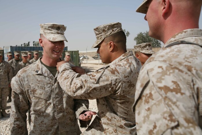 Sgt. Samuel R. Lott, a 23-year-old motor transportation operator from Mojave Valley, Ariz., with Headquarters and Support Company, Regimental Combat Team 1, is promoted Oct. 1 at Camp Ramadi, Iraq. During Lott’s first deployment, he broke his ankle during physical training. During his current tour, while conducting training operations, he fell from a vehicle and broke his collarbone. These injuries may have slowed him down, but not enough to make him ineffective to the regiment. (Official U.S. Marine Corps photo by Cpl. Stephen McGinnis) (RELEASED)